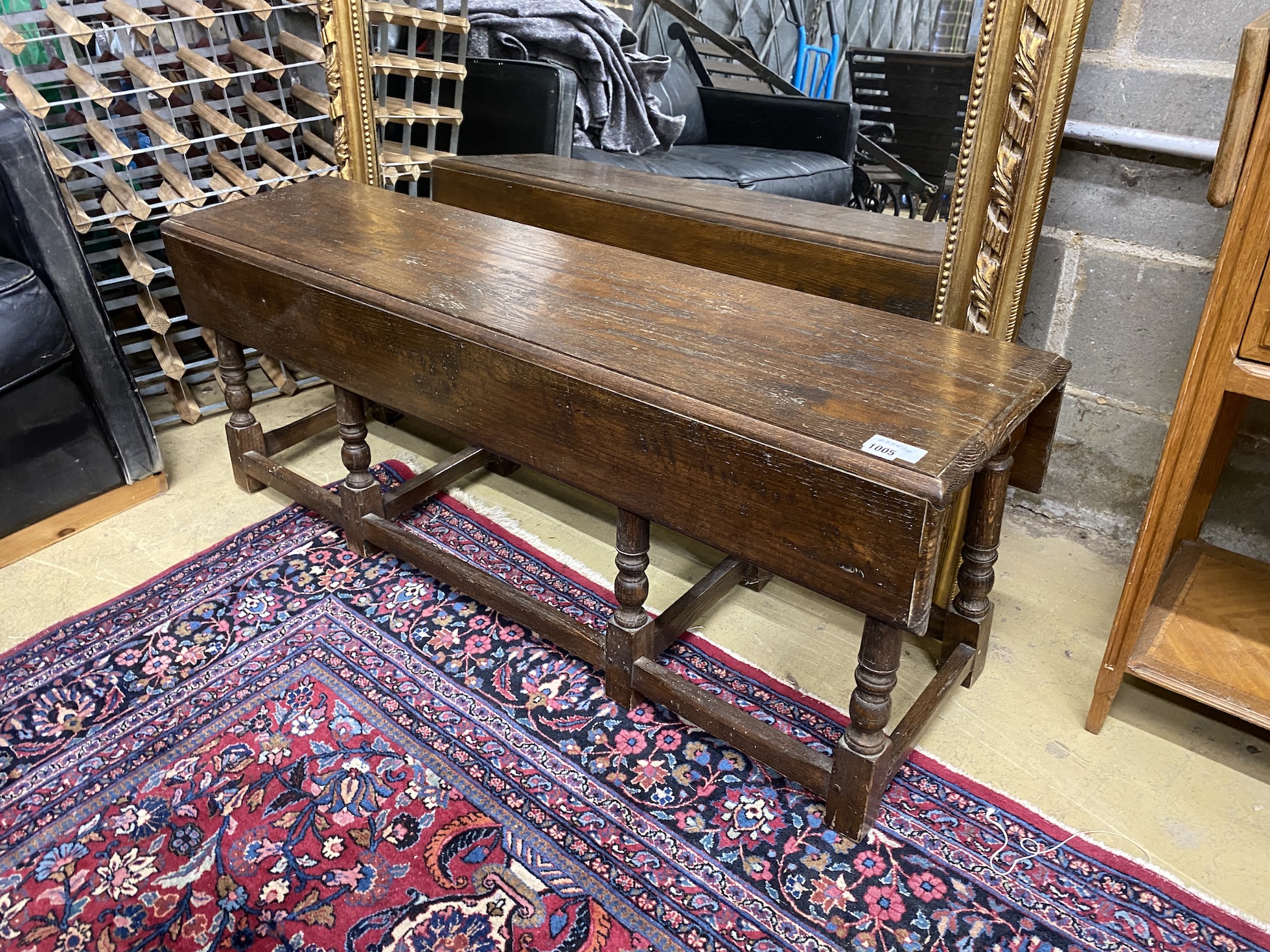 An 18th century style oak drop flap low table, length 130cm, depth 32cm, height 48cm